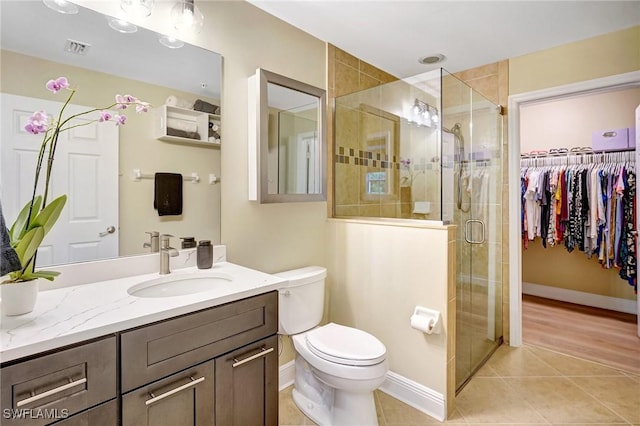 18273 Creekside Preserve Loop Unit 101, Fort Myers, FL 33908 - full bathroom with vanity, tile patterned floors, a stall shower, and a walk in closet