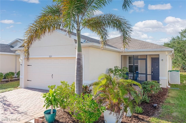 5213 Shell Mound Cir, Punta Gorda, FL 33982 - view of front facade featuring stucco siding, a garage, decorative driveway, and a shingled roof
