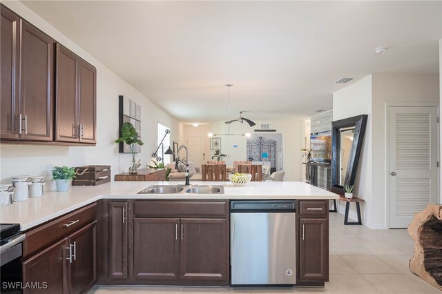 5213 Shell Mound Cir, Punta Gorda, FL 33982 - kitchen with dishwasher, a sink, a peninsula, light countertops, and dark brown cabinetry