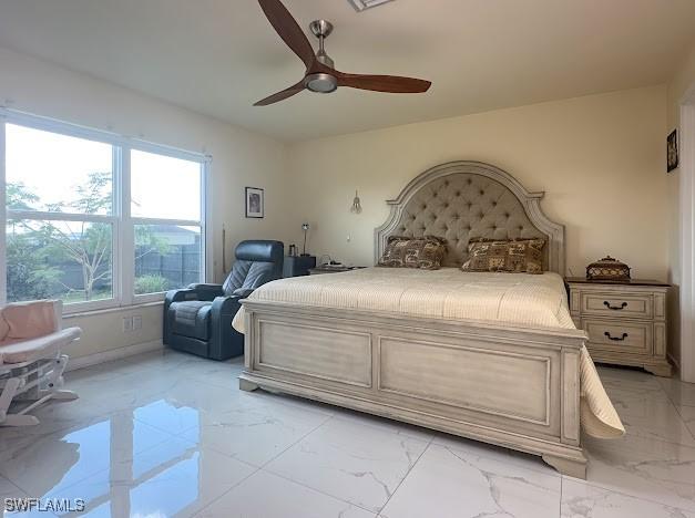 1220 Moore Run, Labelle, FL 33935 - bedroom featuring light marble finish floors, a ceiling fan, and baseboards