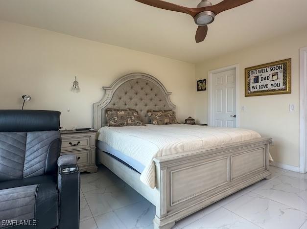 1220 Moore Run, Labelle, FL 33935 - bedroom featuring light marble finish floors, ceiling fan, and baseboards