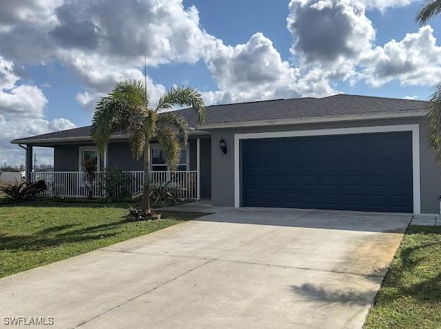 1220 Moore Run, Labelle, FL 33935 - ranch-style home featuring stucco siding, a garage, driveway, and a front lawn
