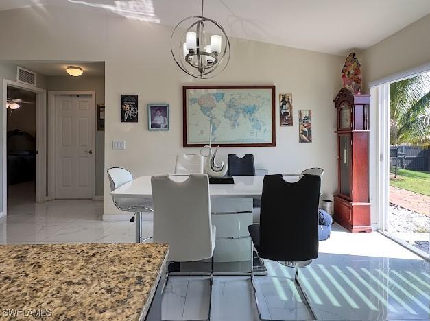 1220 Moore Run, Labelle, FL 33935 - dining space with a chandelier and light marble finish flooring