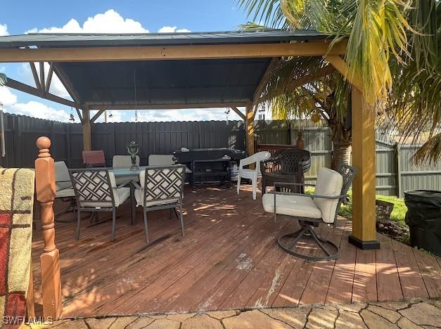 1220 Moore Run, Labelle, FL 33935 - wooden terrace with a gazebo, a fenced backyard, and outdoor dining area