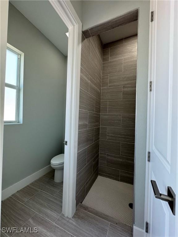 1220 Moore Run, Labelle, FL 33935 - bathroom with toilet, a shower stall, baseboards, and tile patterned floors