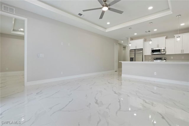 1404 W 12th St, Lehigh Acres, FL 33972 - unfurnished living room with a tray ceiling, a ceiling fan, crown molding, baseboards, and recessed lighting