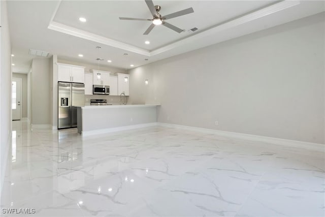 1404 W 12th St, Lehigh Acres, FL 33972 - unfurnished living room with light marble finish floors, a sink, ceiling fan, a tray ceiling, and crown molding