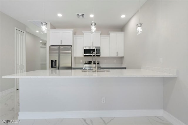 1404 W 12th St, Lehigh Acres, FL 33972 - kitchen with appliances with stainless steel finishes, light marble finish floors, a sink, white cabinets, and recessed lighting