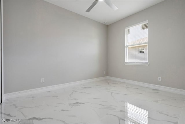 1404 W 12th St, Lehigh Acres, FL 33972 - spare room with marble look tiles, baseboards, and a ceiling fan