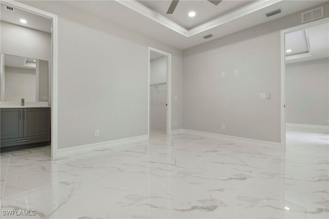 1404 W 12th St, Lehigh Acres, FL 33972 - unfurnished bedroom with a walk in closet, a closet, crown molding, light marble finish floors, and baseboards