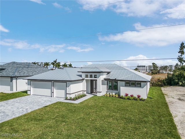 2241 SW 17th Pl, Cape Coral, FL 33991 - view of front of property with decorative driveway, a front lawn, stucco siding, metal roof, and a garage