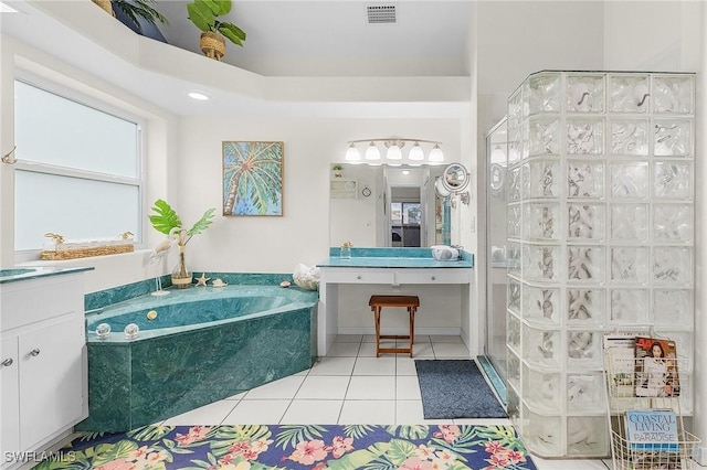 13460 Wild Cotton Ct, North Fort Myers, FL 33903 - bathroom featuring vanity, tile patterned flooring, a garden tub, and a stall shower