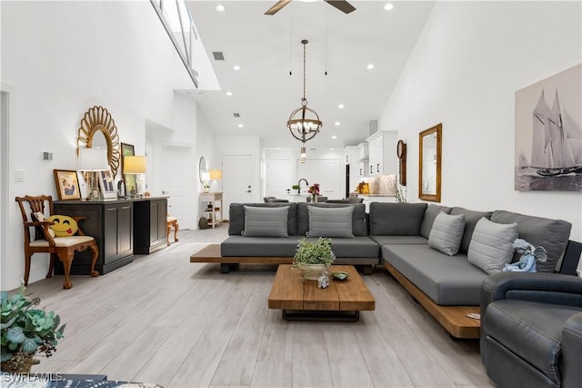 4014 Crayton Rd Unit B4, Naples, FL 34103 - living room with high vaulted ceiling, ceiling fan, a chandelier, light wood-style floors, and recessed lighting