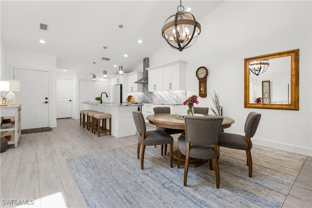 4014 Crayton Rd Unit B4, Naples, FL 34103 - dining area featuring a chandelier, light wood-style floors, recessed lighting, and high vaulted ceiling