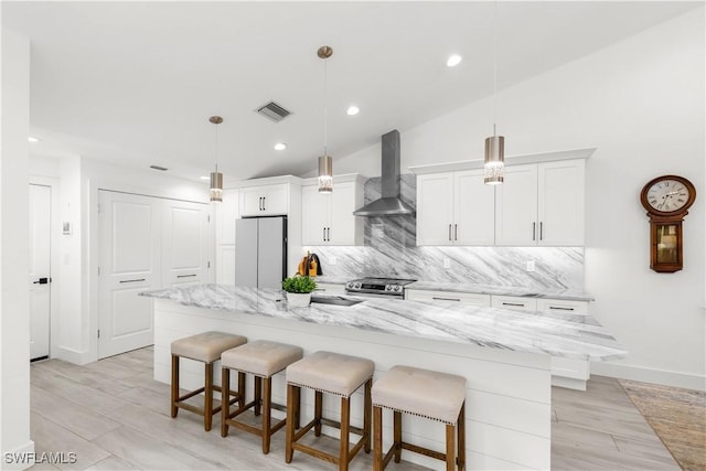 4014 Crayton Rd Unit B4, Naples, FL 34103 - kitchen with wall chimney exhaust hood, freestanding refrigerator, stainless steel range with electric stovetop, white cabinets, and recessed lighting