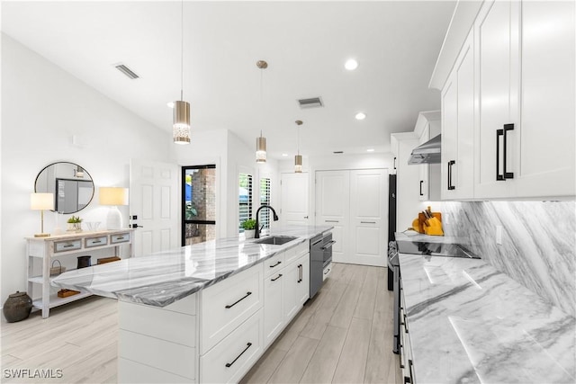 4014 Crayton Rd Unit B4, Naples, FL 34103 - kitchen with a sink, a spacious island, white cabinetry, light stone countertops, and recessed lighting