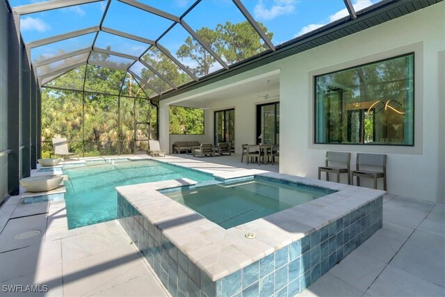 4472 Pine Ridge Rd, Naples, FL 34119 - view of pool featuring a patio area, a pool with connected hot tub, a ceiling fan, and glass enclosure
