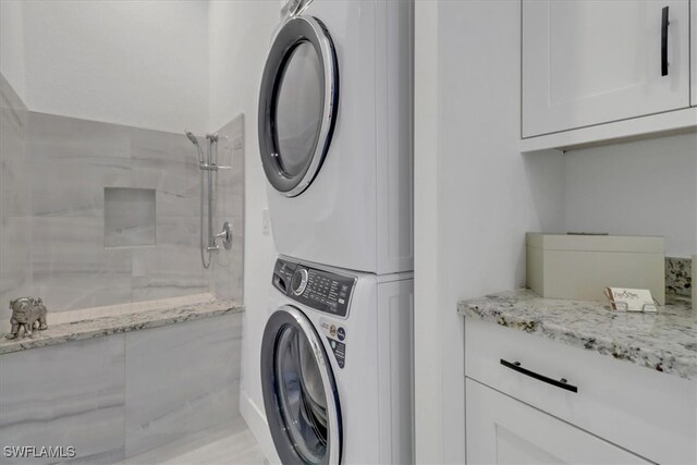 4472 Pine Ridge Rd, Naples, FL 34119 - laundry area featuring stacked washer / dryer