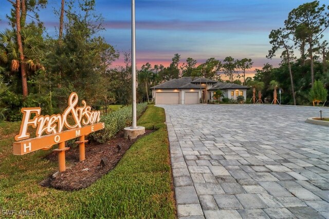 4472 Pine Ridge Rd, Naples, FL 34119 - view of front facade with decorative driveway and an attached garage