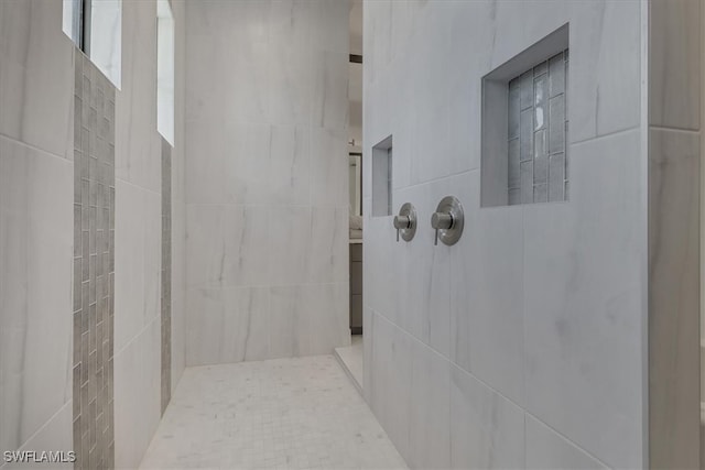 4472 Pine Ridge Rd, Naples, FL 34119 - bathroom featuring tiled shower and tile walls
