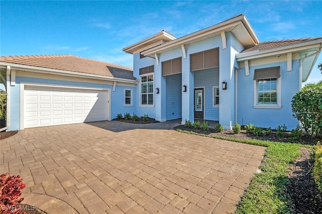 14792 Spinnaker Way, Naples, FL 34114 - view of front of house with a garage, decorative driveway, a tile roof, and stucco siding