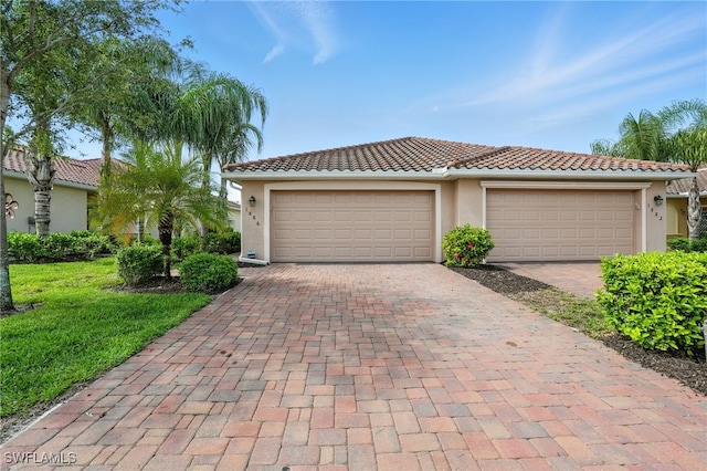 1886 Alameda Dr, Naples, FL 34120 - view of front of property with decorative driveway, stucco siding, a tile roof, and a front yard