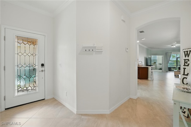 1886 Alameda Dr, Naples, FL 34120 - entrance foyer with arched walkways, ornamental molding, and light tile patterned flooring