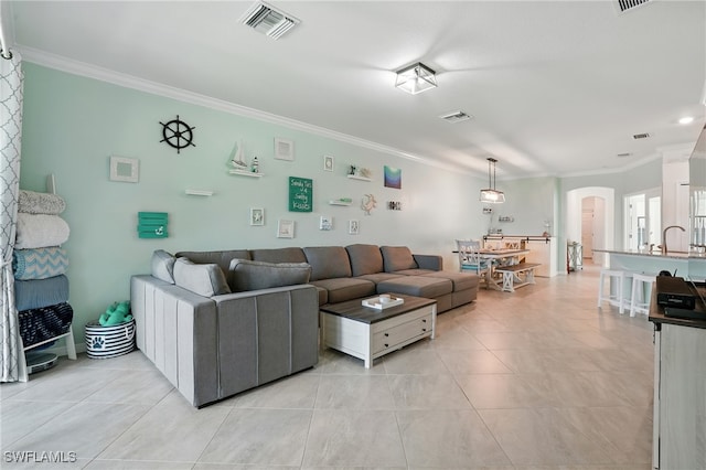 1886 Alameda Dr, Naples, FL 34120 - living room featuring arched walkways, crown molding, and light tile patterned floors
