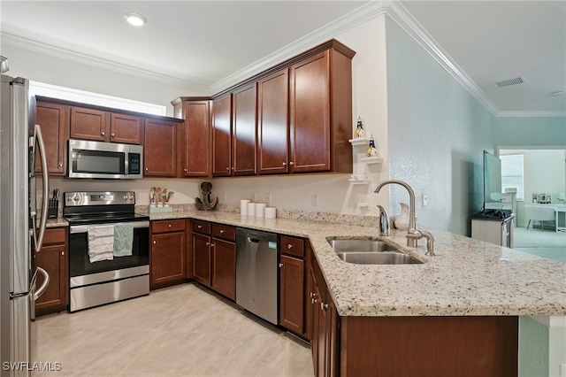 1886 Alameda Dr, Naples, FL 34120 - kitchen with stainless steel appliances, a peninsula, crown molding, light stone counters, and light tile patterned floors