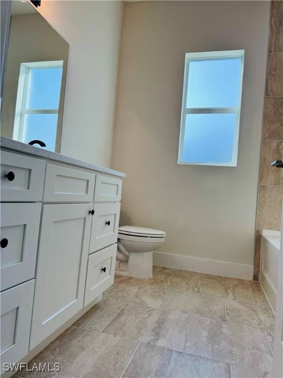 1062 Jay Ct, Labelle, FL 33935 - bathroom featuring toilet, healthy amount of natural light, baseboards, and washtub / shower combination