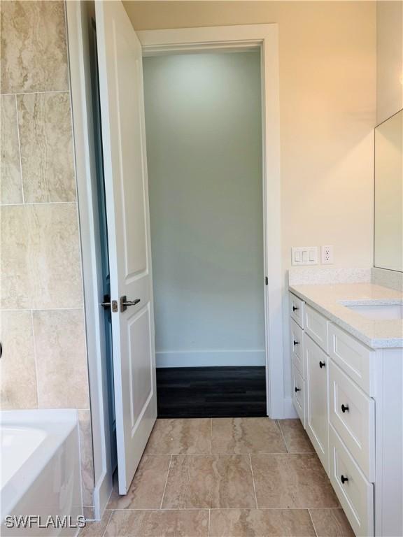 1062 Jay Ct, Labelle, FL 33935 - bathroom with vanity, a tub, and baseboards