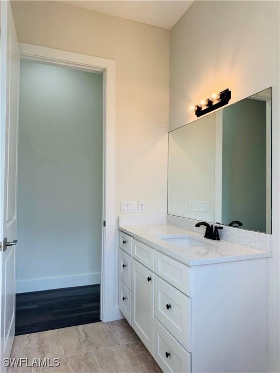 1062 Jay Ct, Labelle, FL 33935 - bathroom featuring vanity, baseboards, and tile patterned floors