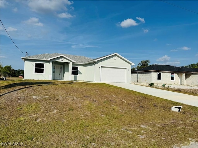 1062 Jay Ct, Labelle, FL 33935 - ranch-style house with concrete driveway, an attached garage, and a front lawn