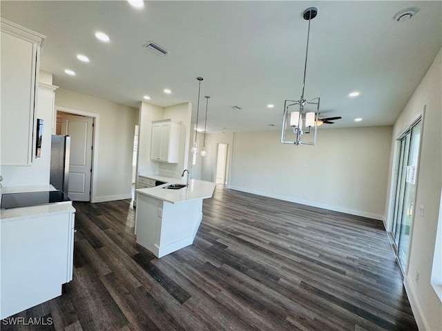 1062 Jay Ct, Labelle, FL 33935 - kitchen with a sink, recessed lighting, dark wood-type flooring, white cabinets, and baseboards