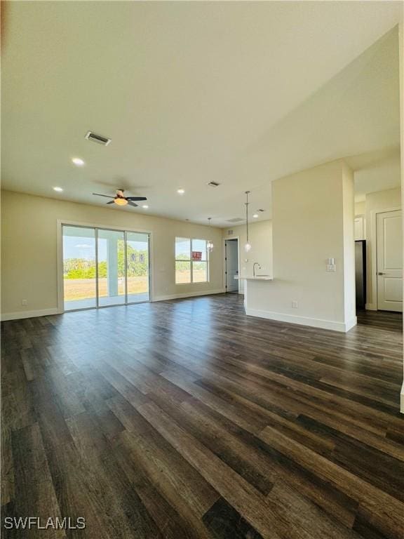 1062 Jay Ct, Labelle, FL 33935 - unfurnished living room featuring baseboards, dark wood-type flooring, ceiling fan, and recessed lighting