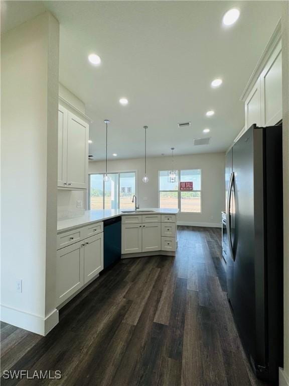 1062 Jay Ct, Labelle, FL 33935 - kitchen featuring stainless steel fridge, a peninsula, dishwasher, baseboards, and recessed lighting