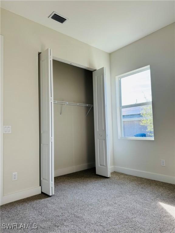 1062 Jay Ct, Labelle, FL 33935 - unfurnished bedroom with carpet, a closet, and baseboards