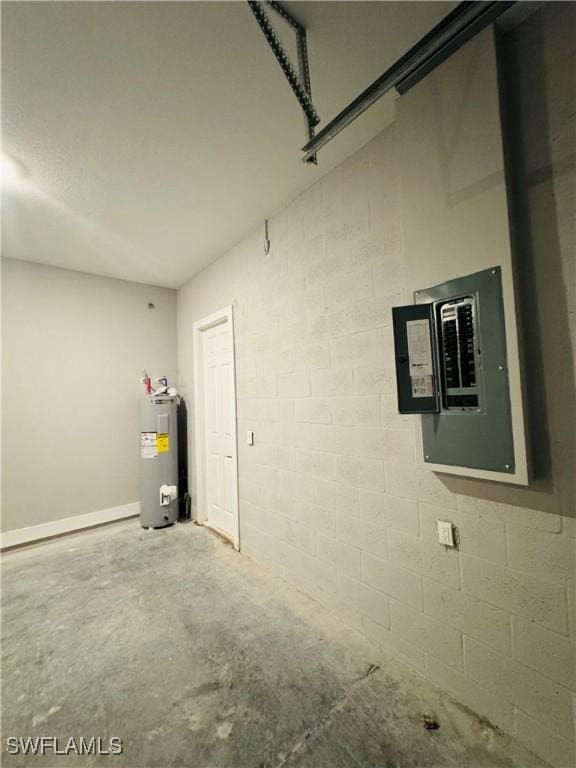 1062 Jay Ct, Labelle, FL 33935 - garage featuring water heater, electric panel, and concrete block wall