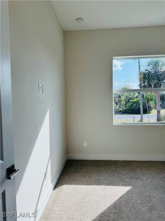 1062 Jay Ct, Labelle, FL 33935 - empty room with carpet, baseboards, and a smoke detector