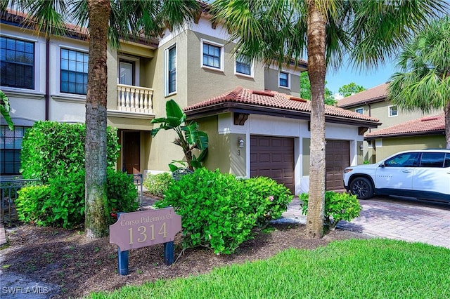 1314 Corso Palermo Ct Unit 1802, Naples, FL 34105 - mediterranean / spanish-style home with stucco siding, driveway, a tiled roof, and an attached garage