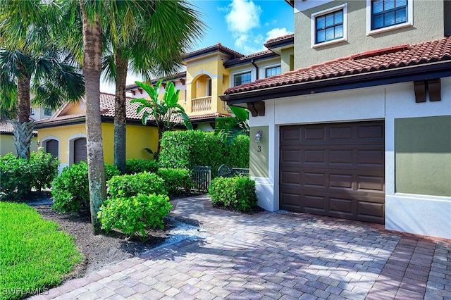 1314 Corso Palermo Ct Unit 1802, Naples, FL 34105 - mediterranean / spanish-style home with an attached garage, stucco siding, and a tiled roof