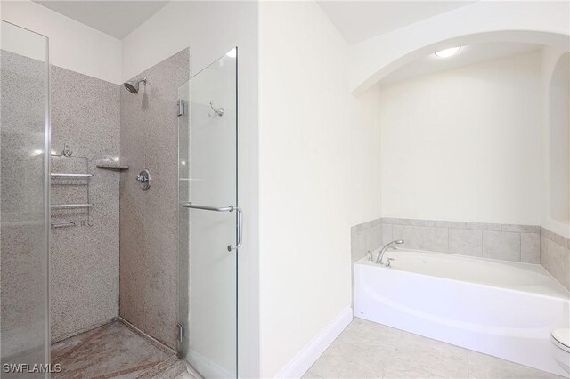 1314 Corso Palermo Ct Unit 1802, Naples, FL 34105 - bathroom with a shower stall, a garden tub, tile patterned flooring, baseboards, and toilet