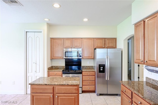 1314 Corso Palermo Ct Unit 1802, Naples, FL 34105 - kitchen featuring appliances with stainless steel finishes, arched walkways, light tile patterned floors, light stone counters, and recessed lighting