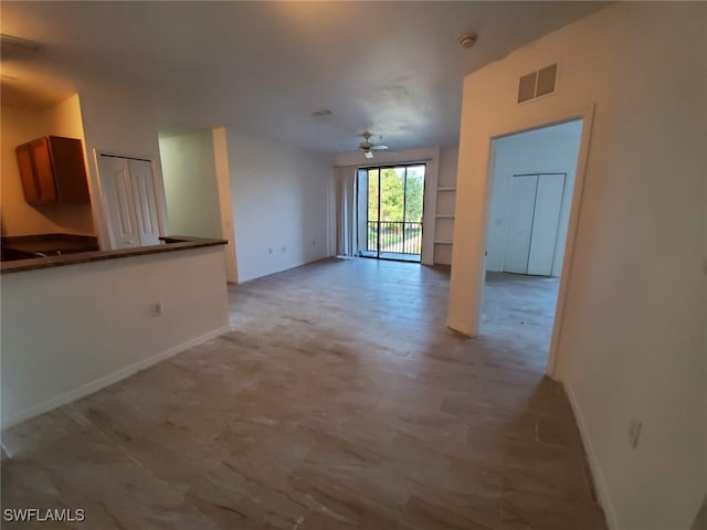 6141 Metrowest Blvd Unit 206, Orlando, FL 32835 - unfurnished living room with ceiling fan and baseboards