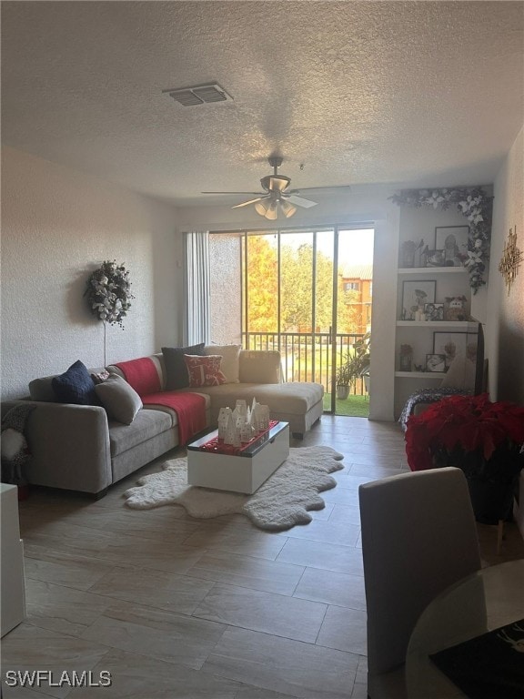 6141 Metrowest Blvd Unit 206, Orlando, FL 32835 - living area featuring ceiling fan and a textured ceiling