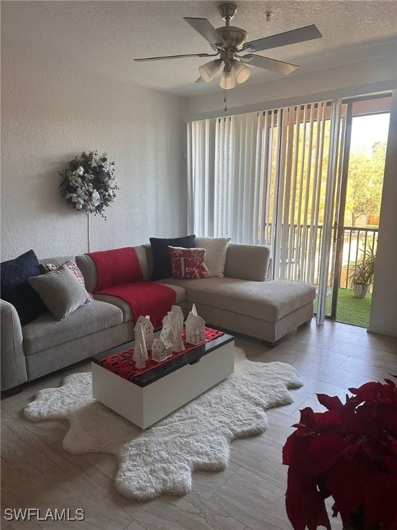 6141 Metrowest Blvd Unit 206, Orlando, FL 32835 - living area with healthy amount of natural light, ceiling fan, a textured ceiling, and wood finished floors