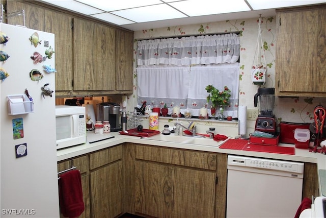 1210 SE 6th Ter Unit 87, Cape Coral, FL 33990 - kitchen featuring white appliances, a sink, light countertops, and brown cabinetry