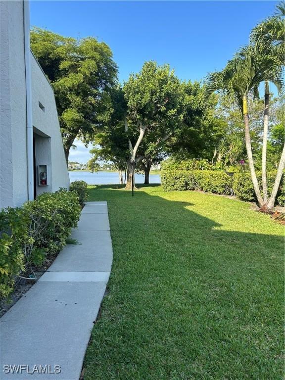 3062 Kings Lake Blvd Unit 7511, Naples, FL 34112 - view of grassy yard with a water view