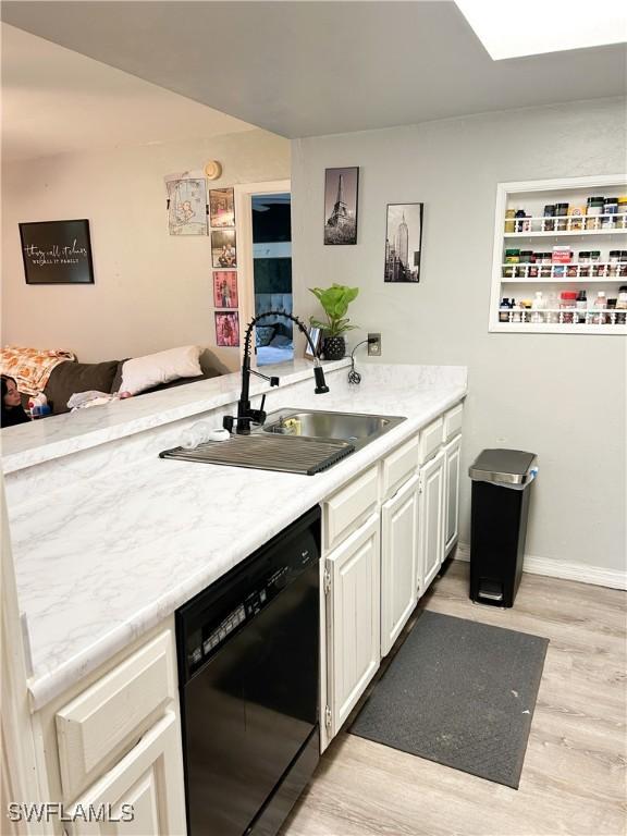 3062 Kings Lake Blvd Unit 7511, Naples, FL 34112 - kitchen with dishwasher, light wood-type flooring, white cabinetry, a peninsula, and open floor plan