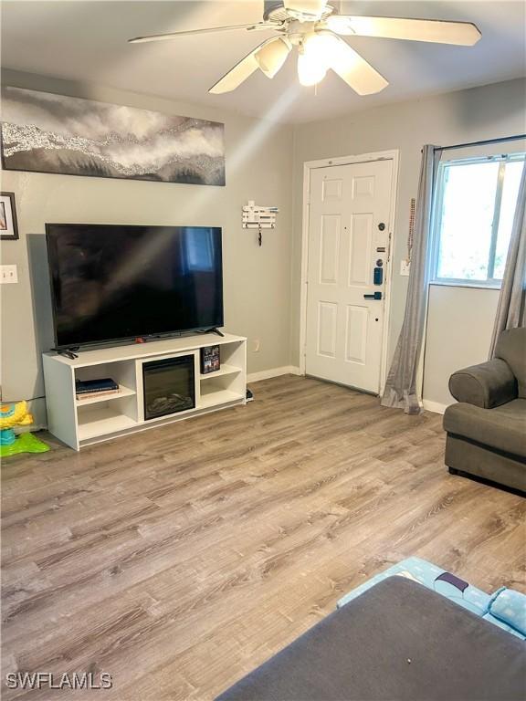 3062 Kings Lake Blvd Unit 7511, Naples, FL 34112 - living room featuring wood finished floors and a ceiling fan